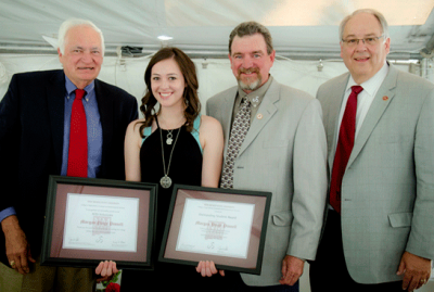 Image of Morgan Pinnells induction into the Sam Steel Society upon graduation.